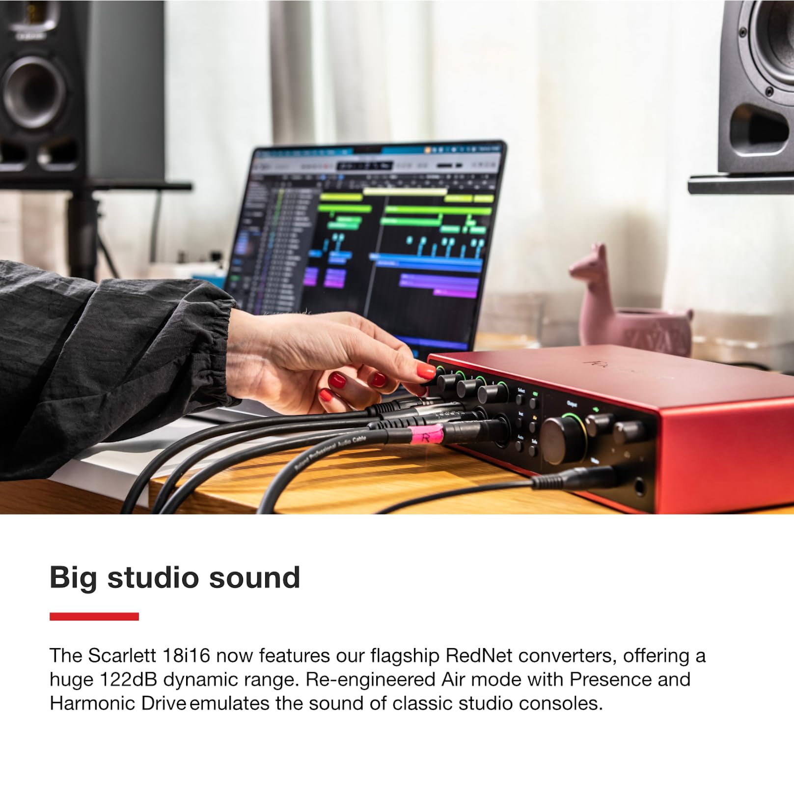 Red Focusrite Scarlett 18i16 USB audio interface connected to laptop with cables