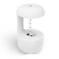 White cool mist humidifier with suspended droplets over the circular top nozzle opening.