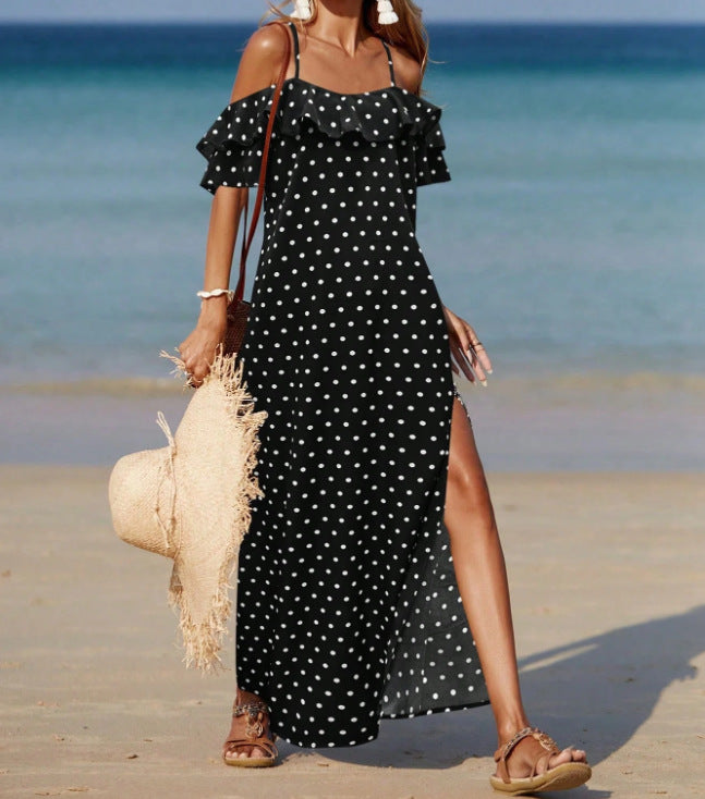 Off-shoulder long polka dot dress in black with white dots, ruffled sleeves and side slit