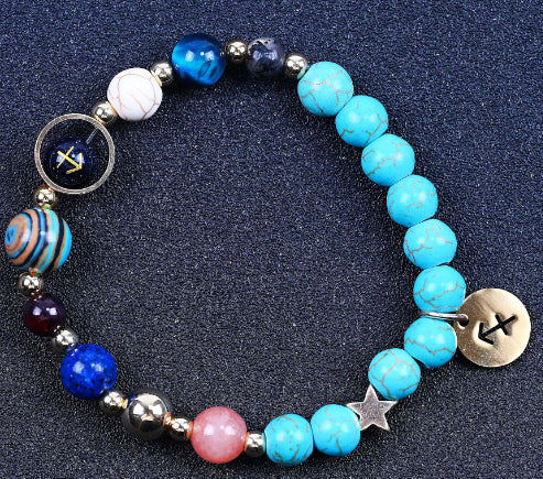 Turquoise beaded bracelet with mixed beads and gold-tone zodiac charm disk on end