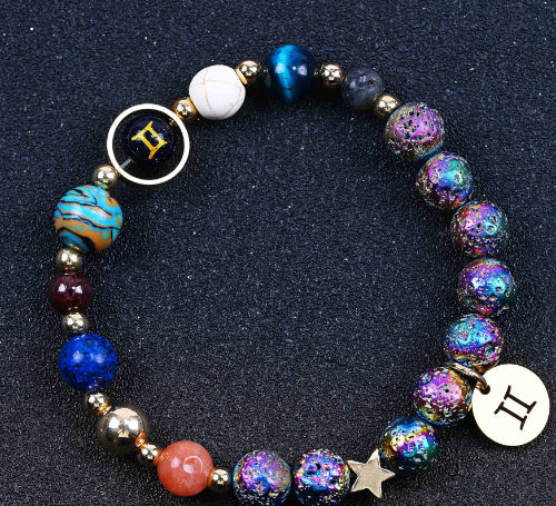 Beaded bracelet with blue and purple iridescent beads, star charm, and round zodiac pendant