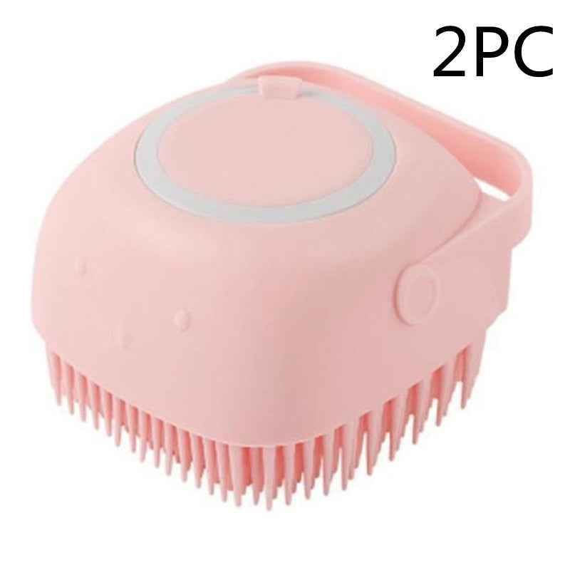 Pink silicone pet grooming brush with oval massage pad and side carry handle