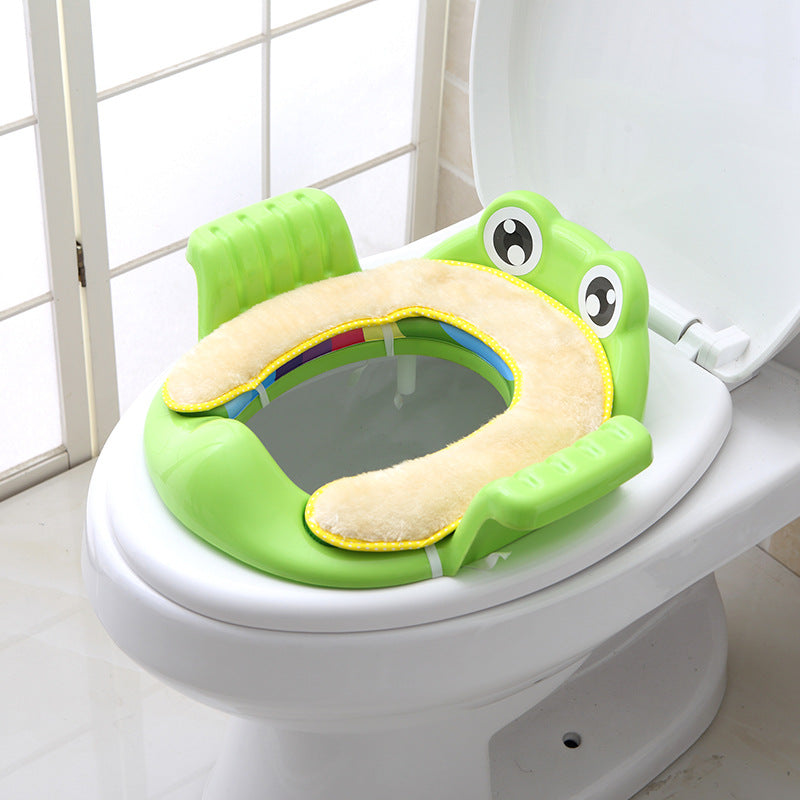 Green toddler toilet seat with animal face and beige cushioned inner pad
