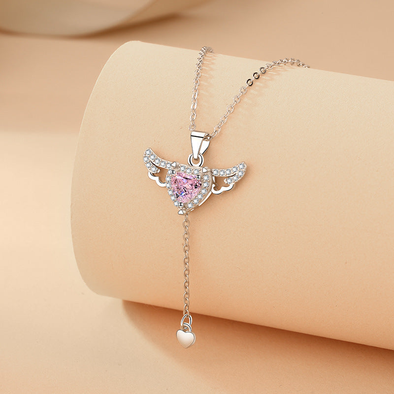 Silver-toned angel wing heart necklace with pink crystal pendant and heart tail charm