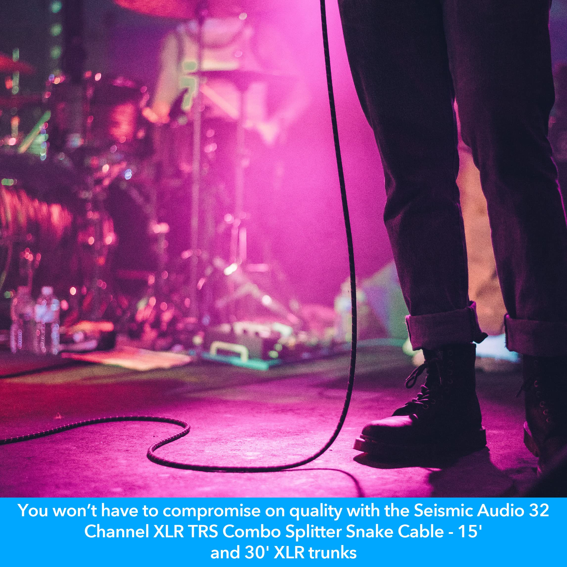 Audio splitter snake cable trailing across a stage floor with coiled lead near feet.