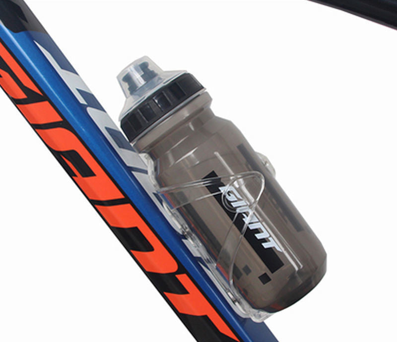 Grey translucent cycling water bottle with flip-top cap, mounted on blue bike frame