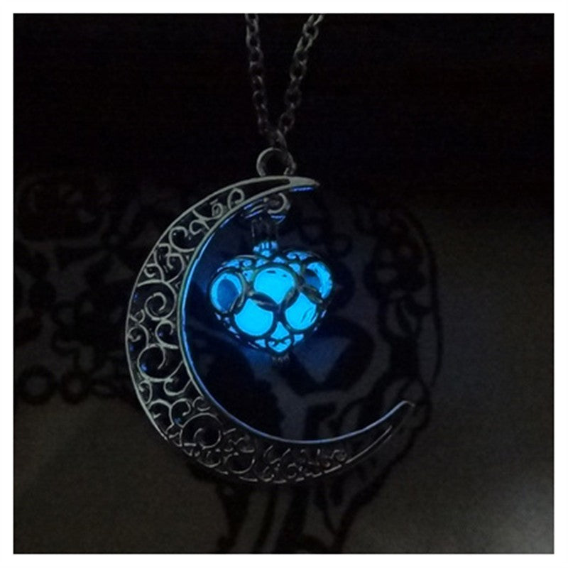 Glowing blue moon pendant with cat face charm on a silver chain