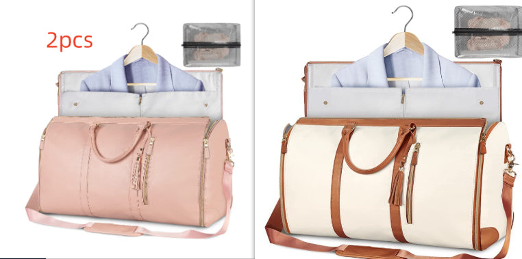 Blush pink foldable travel duffle bag with front zipper, tassel pulls, shoulder strap