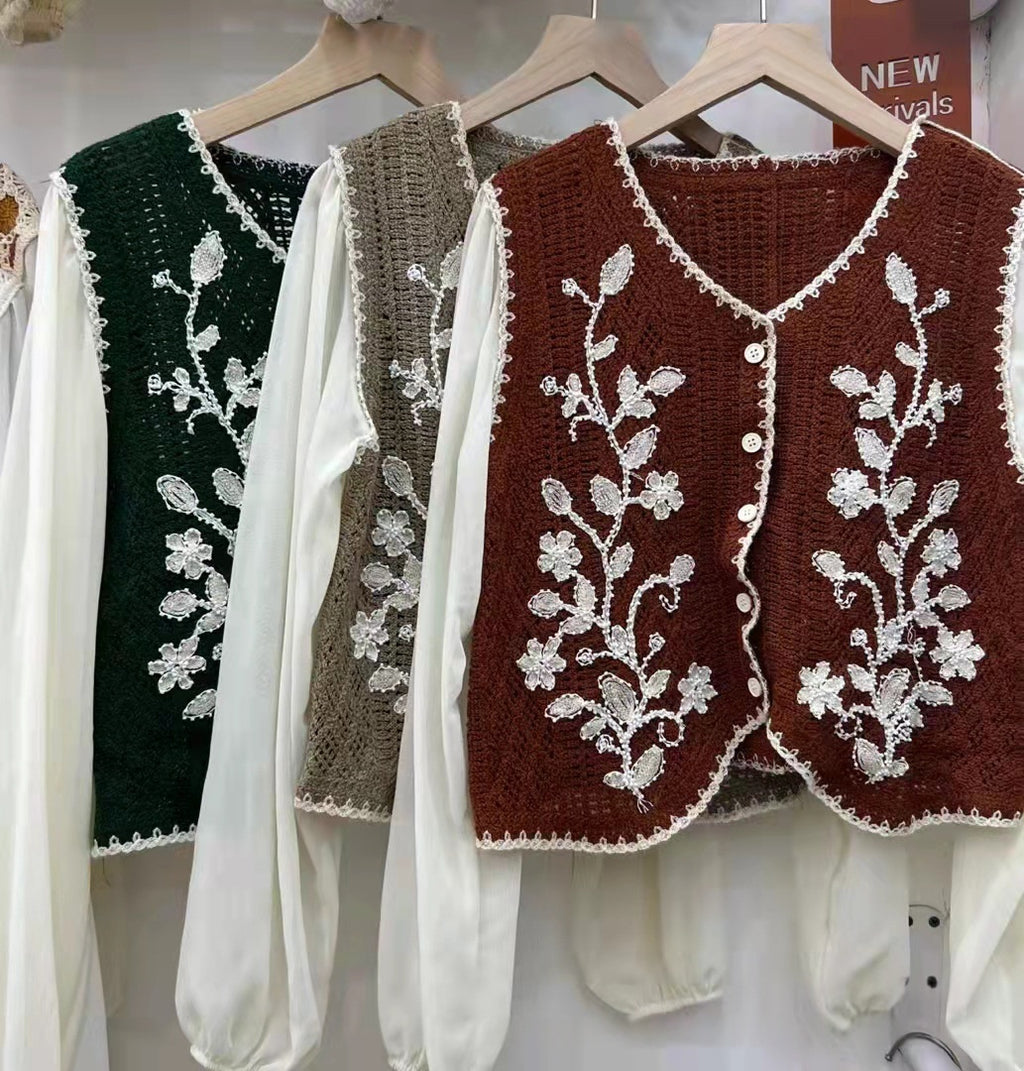 Embroidered V-neck sleeveless tops, dark green, taupe and maroon, on hangers
