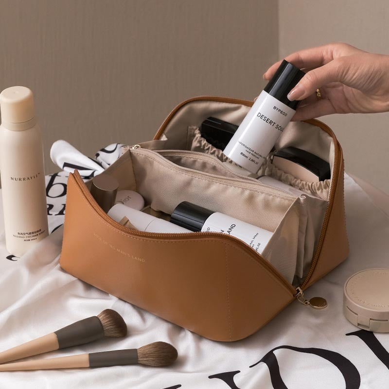 Large travel cosmetic bag in tan with open top and inner storage compartments