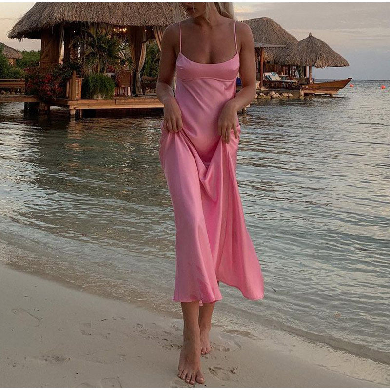 Pink satin midi slip dress with spaghetti straps and soft draped skirt