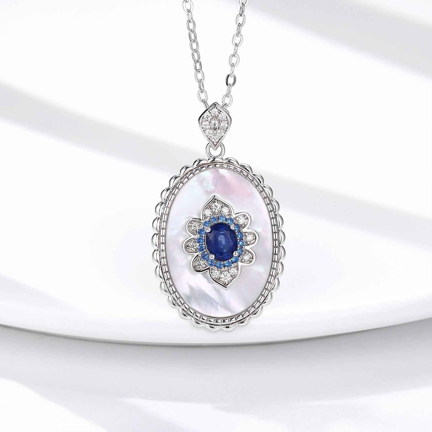 Oval sapphire diamond pendant necklace in sterling silver with blue center stone and chain
