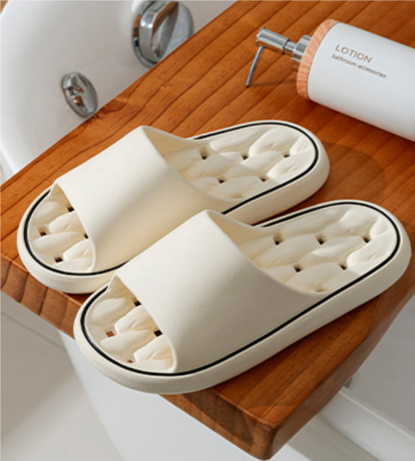 Off-white open-toe slide slippers with thick sole and molded cushioned footbed.