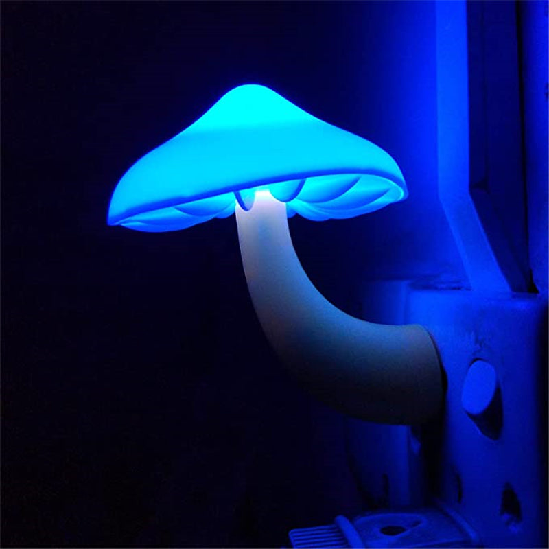 Plug-in mushroom LED night light glowing blue from wall outlet