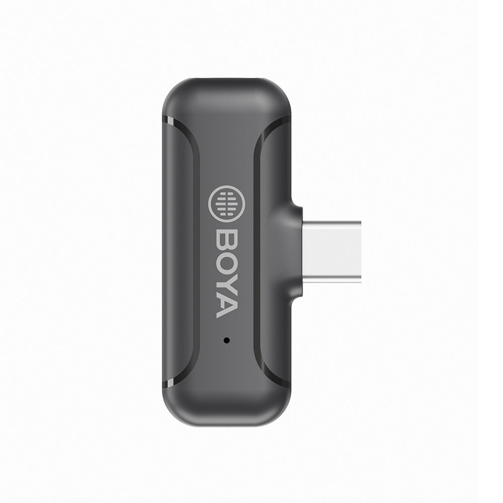 Black BOYA clip-on radio microphone with USB plug, close-up