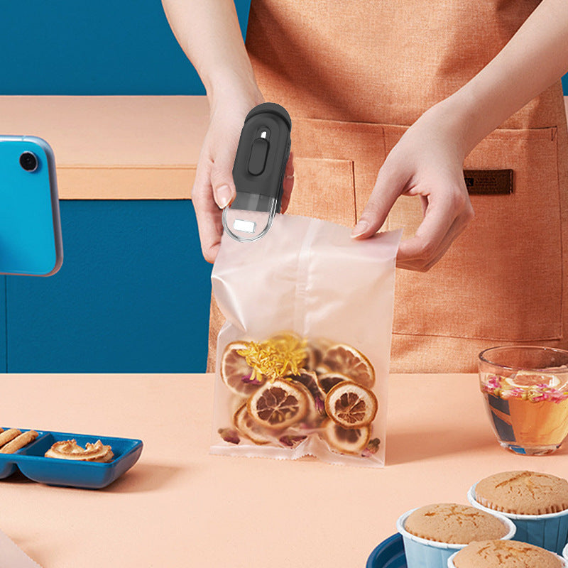 Mini bag sealer tool sealing a clear plastic bag of food