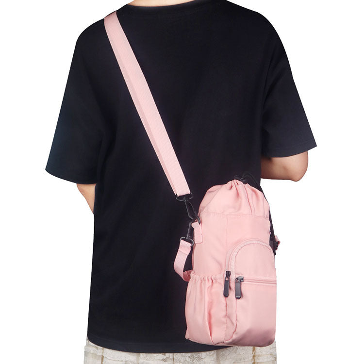 Pink bottle pouch shoulder bag with crossbody strap and front zip pocket