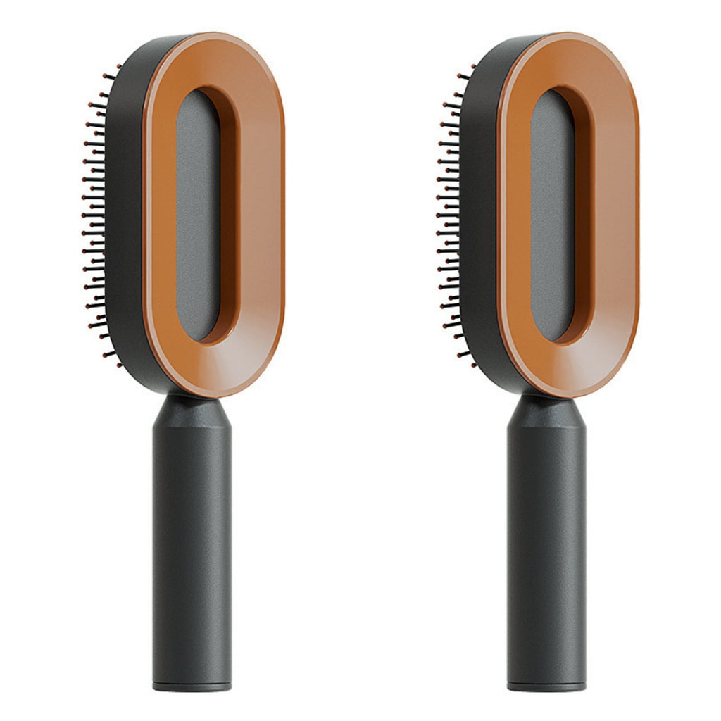 Set of self-cleaning hair brushes with black handles and tan oval heads