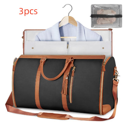 Black travel duffle bag with brown trim, tassel zipper pulls, and hanging shirt organizer