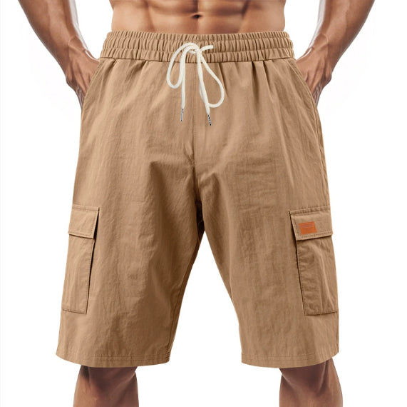 Tan linen cargo shorts with elastic waistband and drawstring, side flap pockets