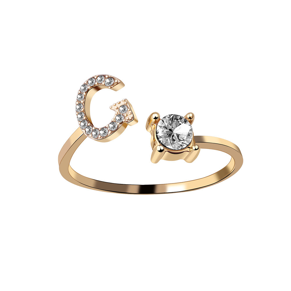 Adjustable initial letter ring with crystal letter detail and round center stone, gold-tone