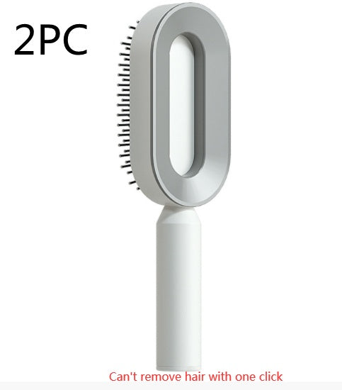 Self-cleaning hair brush with white handle and light gray oval brush head