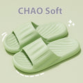 Light green slide slippers with striped strap and molded ribbed footbed