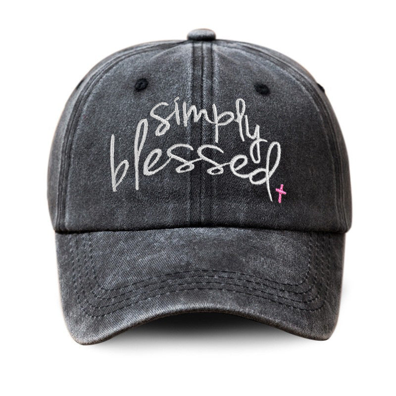 Dark gray washed baseball cap with embroidered "Simply Blessed" script and pink cross