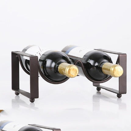 Black wine bottle rack with two curved holders and two displayed bottles