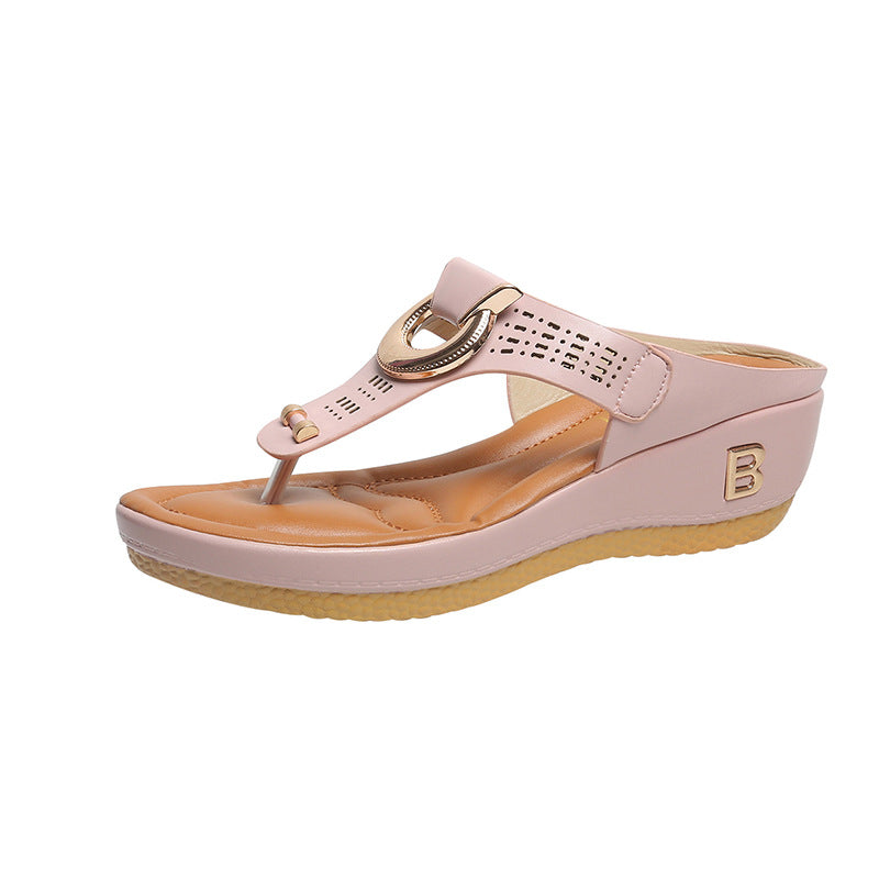 Women’s flower wedge platform flip flops in pink with perforated strap, ring buckle, and wedge sole