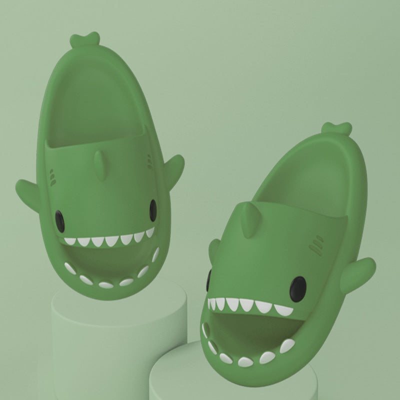 Cartoon shark slippers pair in dark green, padded slides with toothy grin