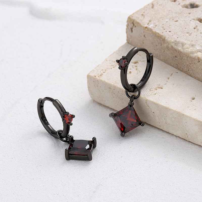 Black gold hoop earrings with red crystal dangle charms