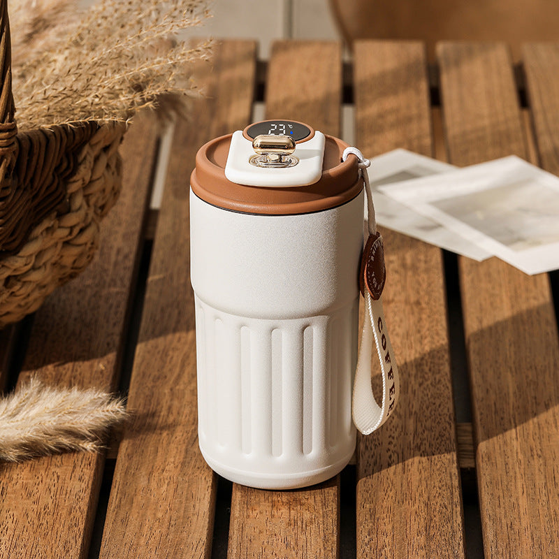 White vacuum insulated coffee mug thermos with digital lid and brown trim, with carry strap