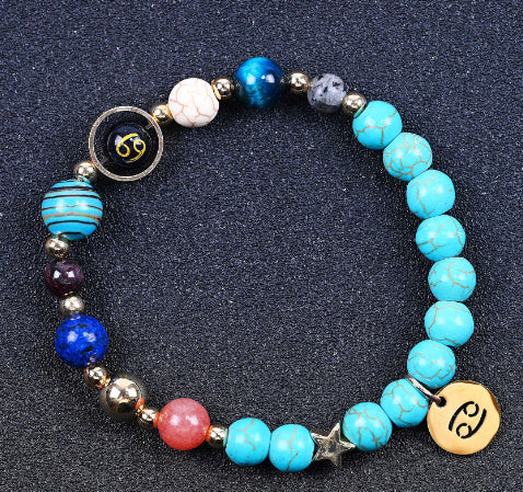 Turquoise beaded bracelet with mixed beads and round zodiac charm disks, with a star accent