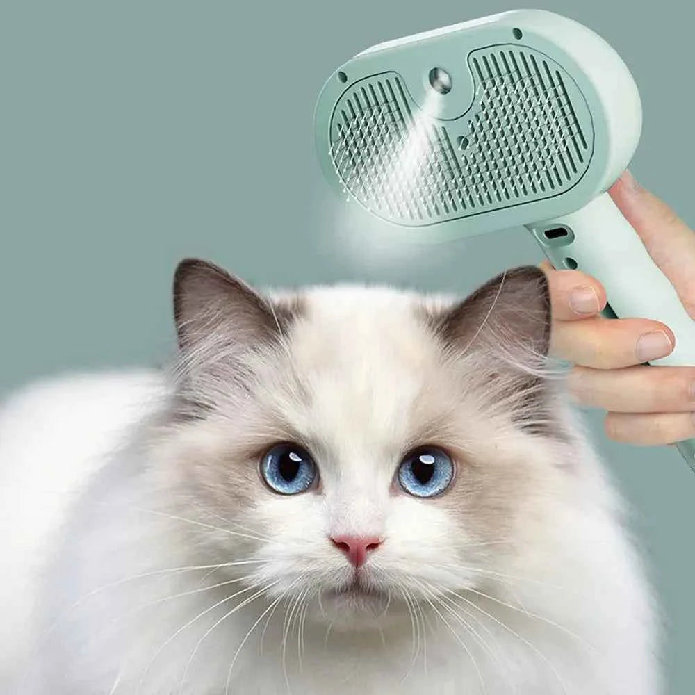 Pet hair grooming brush comb with mint head, held above a white cat